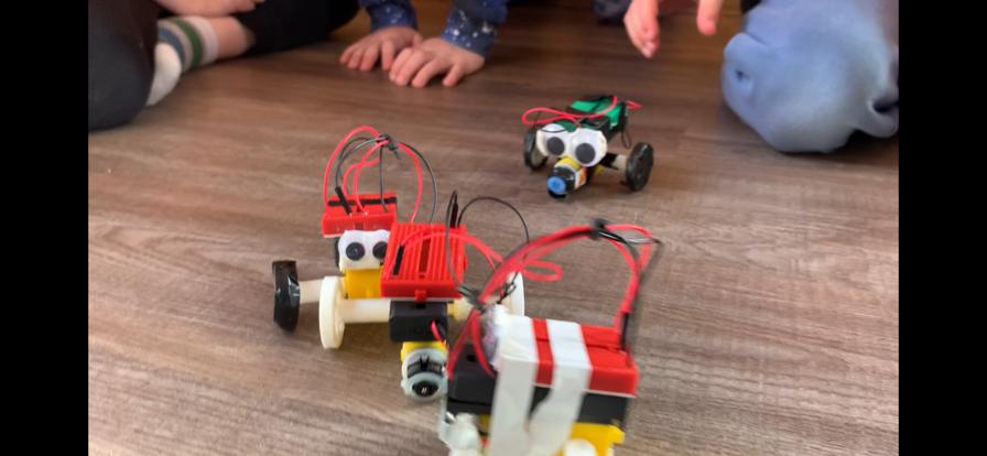 Kids' robot creations with googly eyes built at Robot School